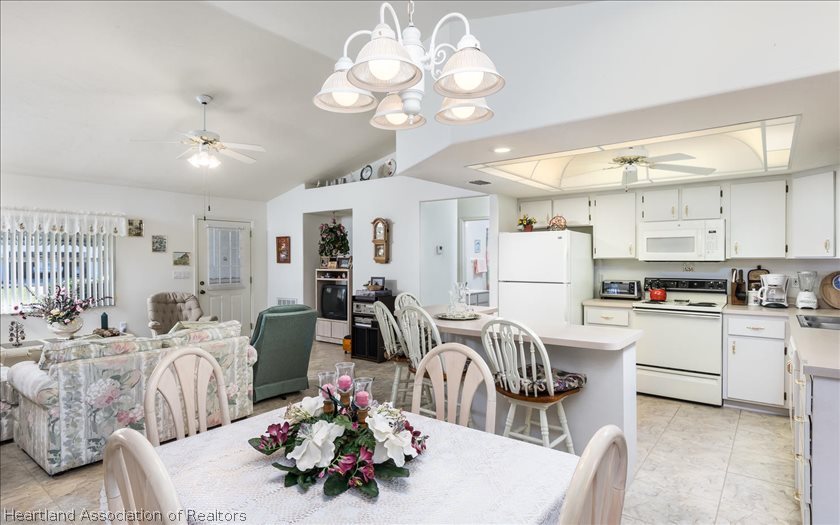 4435 Leaf Road Sebring, FL 33875 - Photo 4 of 16 a living room with kitchen island furniture and a chandelier