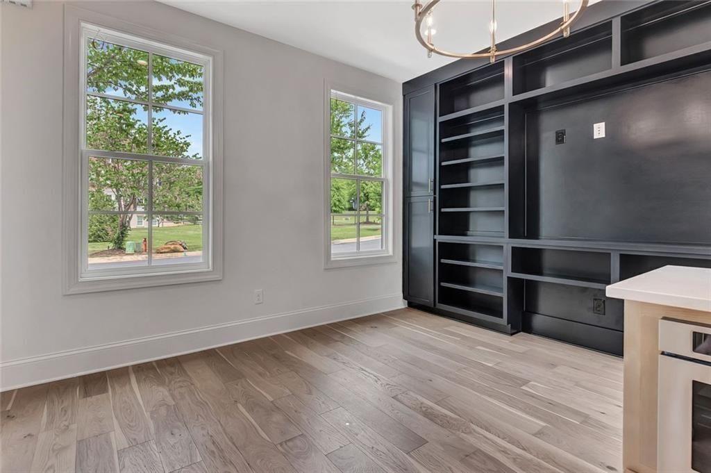 124 Morgan Street Senoia, GA 30276 - Photo 11 of 25 a view of an empty room with a window and wooden floor