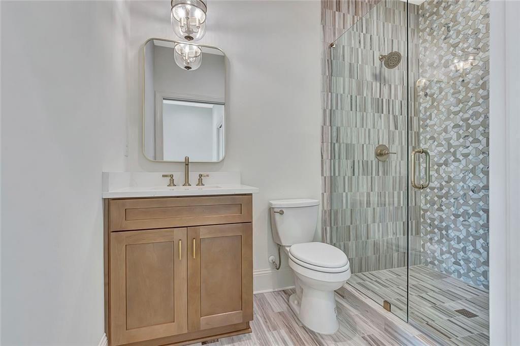 124 Morgan Street Senoia, GA 30276 - Photo 14 of 25 a bathroom with a toilet a sink and a mirror