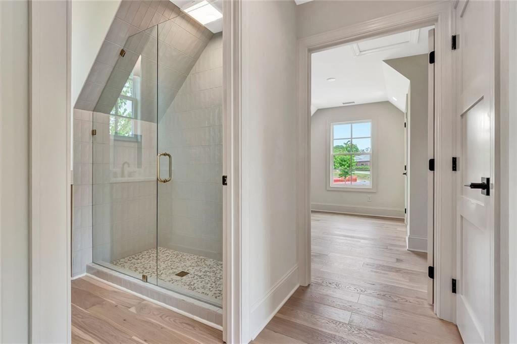 124 Morgan Street Senoia, GA 30276 - Photo 15 of 25 a bathroom with a glass shower door and a window