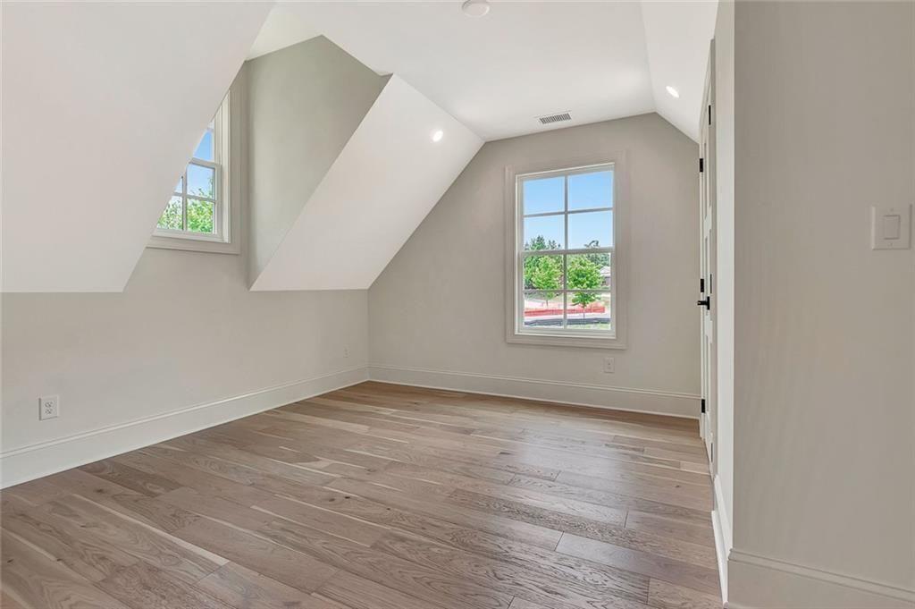 124 Morgan Street Senoia, GA 30276 - Photo 17 of 25 an empty room with wooden floor and windows