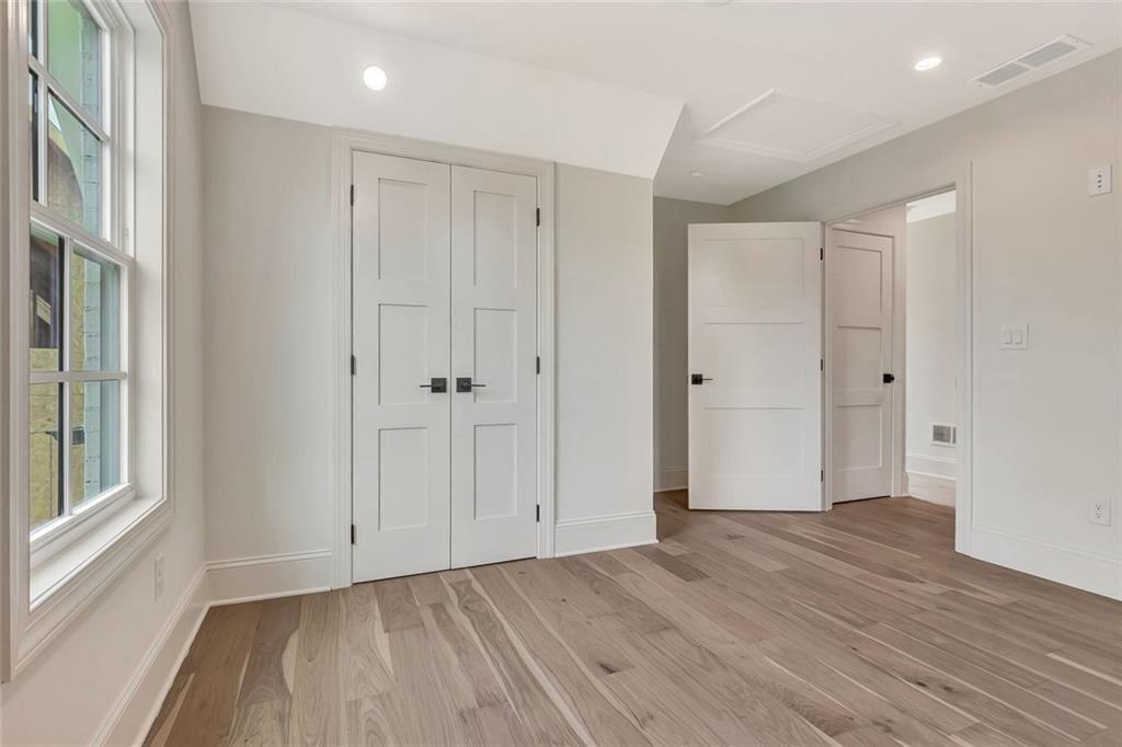 124 Morgan Street Senoia, GA 30276 - Photo 18 of 25 a view of an empty room with wooden floor and a window