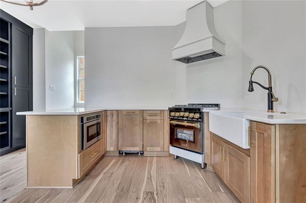 124 Morgan Street Senoia, GA 30276 - Photo 8 of 25 a kitchen with a refrigerator and a stove