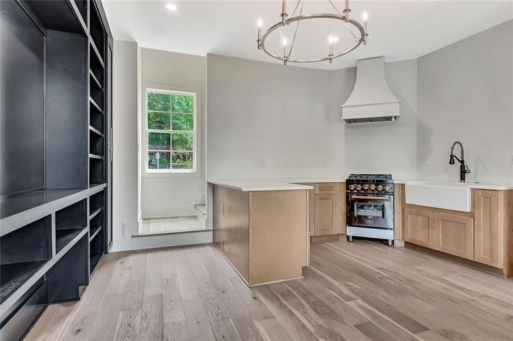 124 Morgan Street Senoia, GA 30276 - Photo 9 of 25 a kitchen with cabinets and wooden floor