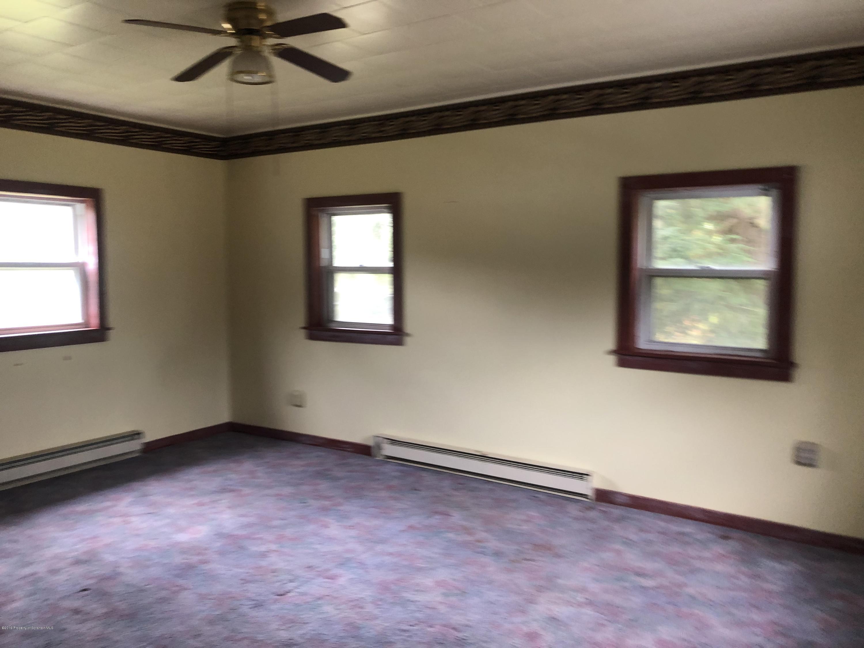 1067 Preacher Brook Road Monroeton, PA 18832 - Photo 13 of 32 an empty room with a window and a ceiling fan