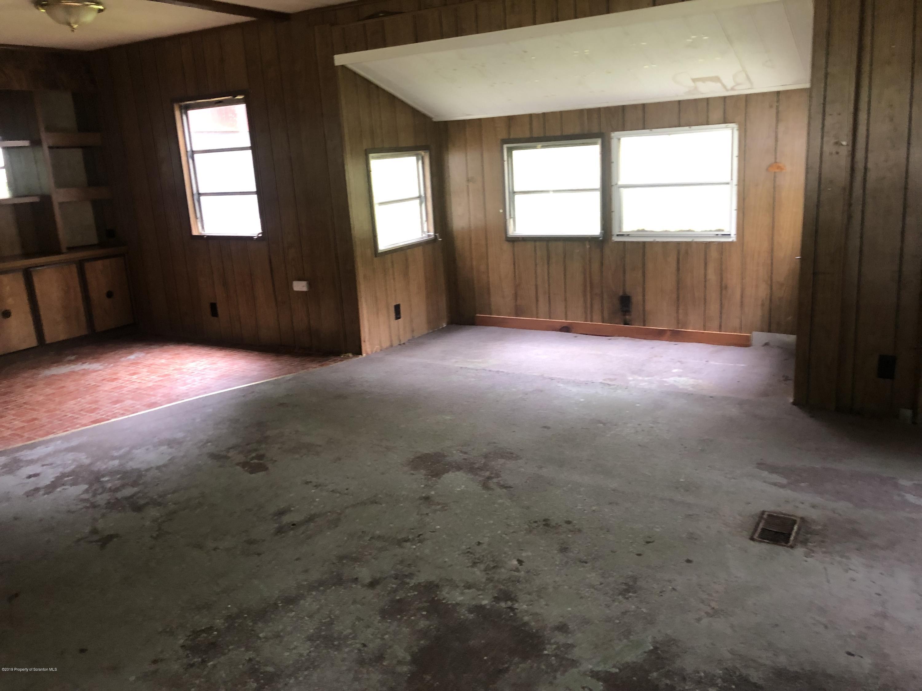 1067 Preacher Brook Road Monroeton, PA 18832 - Photo 21 of 32 an empty room with windows cabinet and front door