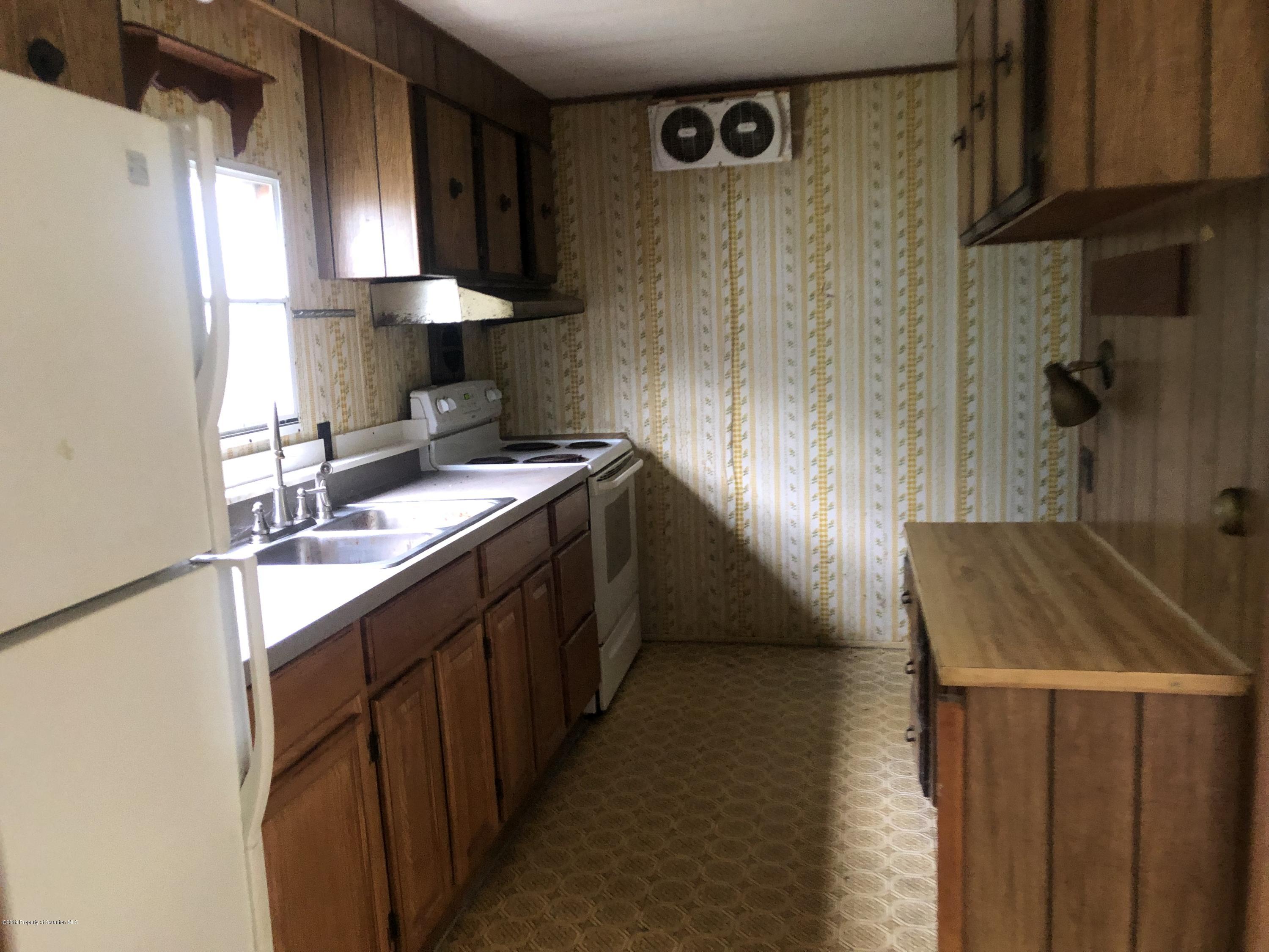 1067 Preacher Brook Road Monroeton, PA 18832 - Photo 23 of 32 a kitchen with a sink stove and cabinets