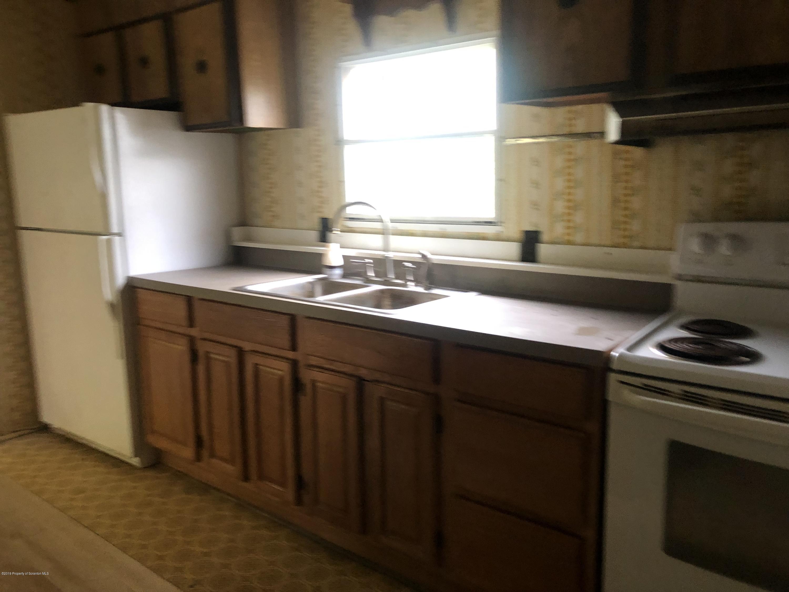 1067 Preacher Brook Road Monroeton, PA 18832 - Photo 29 of 32 a kitchen with stainless steel appliances a sink stove and cabinets
