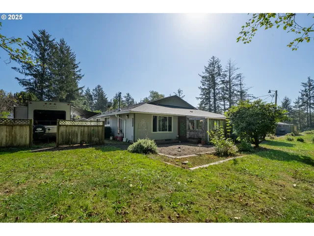 a view of a house with a yard and sitting area