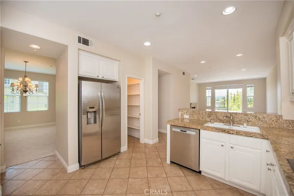 a kitchen with stainless steel appliances cabinets and a refrigerator