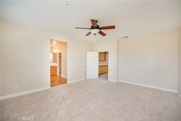 a view of an empty room with window and cabinet