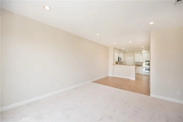 a view of kitchen and empty room