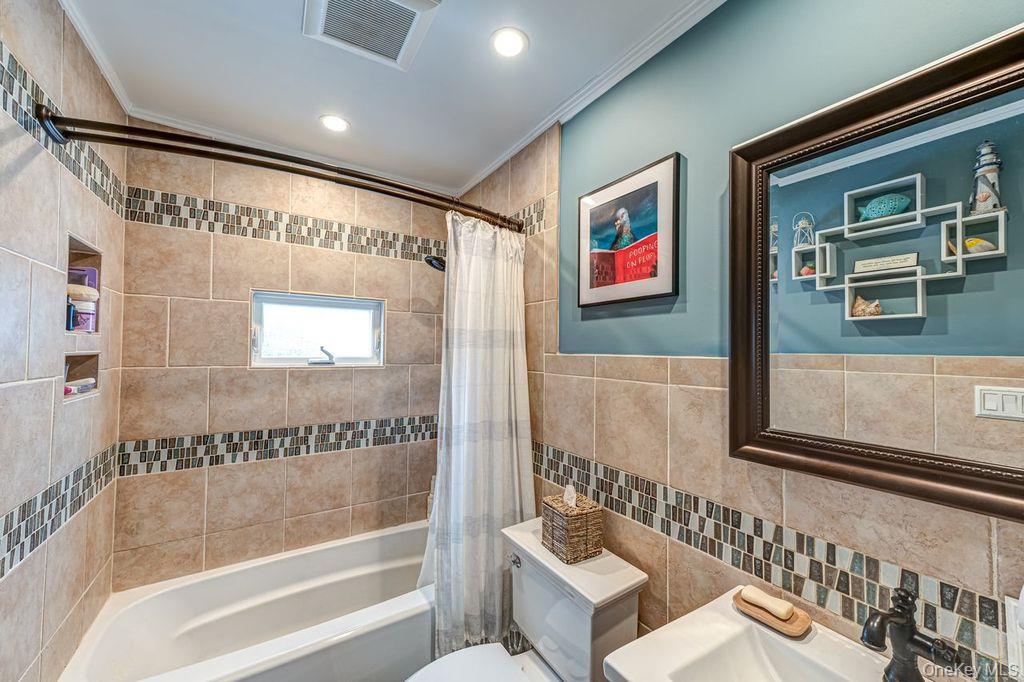 4 Hollyberry Road Plainview, NY 11803 - Photo 13 of 20 a bathroom with a bathtub and a shower