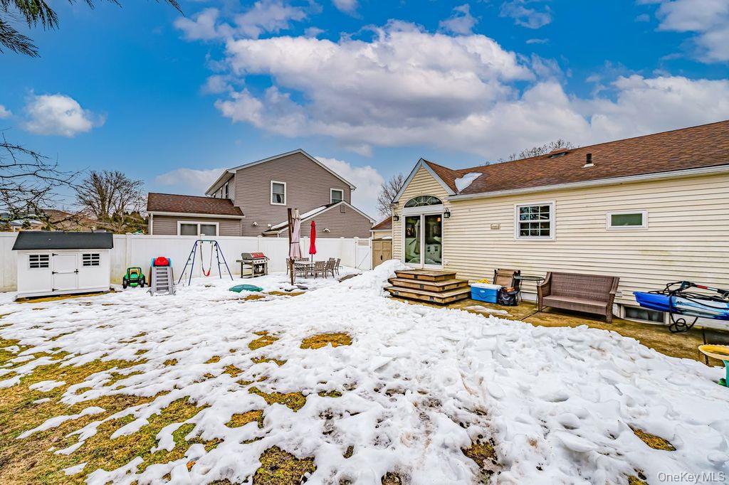 4 Hollyberry Road Plainview, NY 11803 - Photo 17 of 20 a view of a house with snow on roof