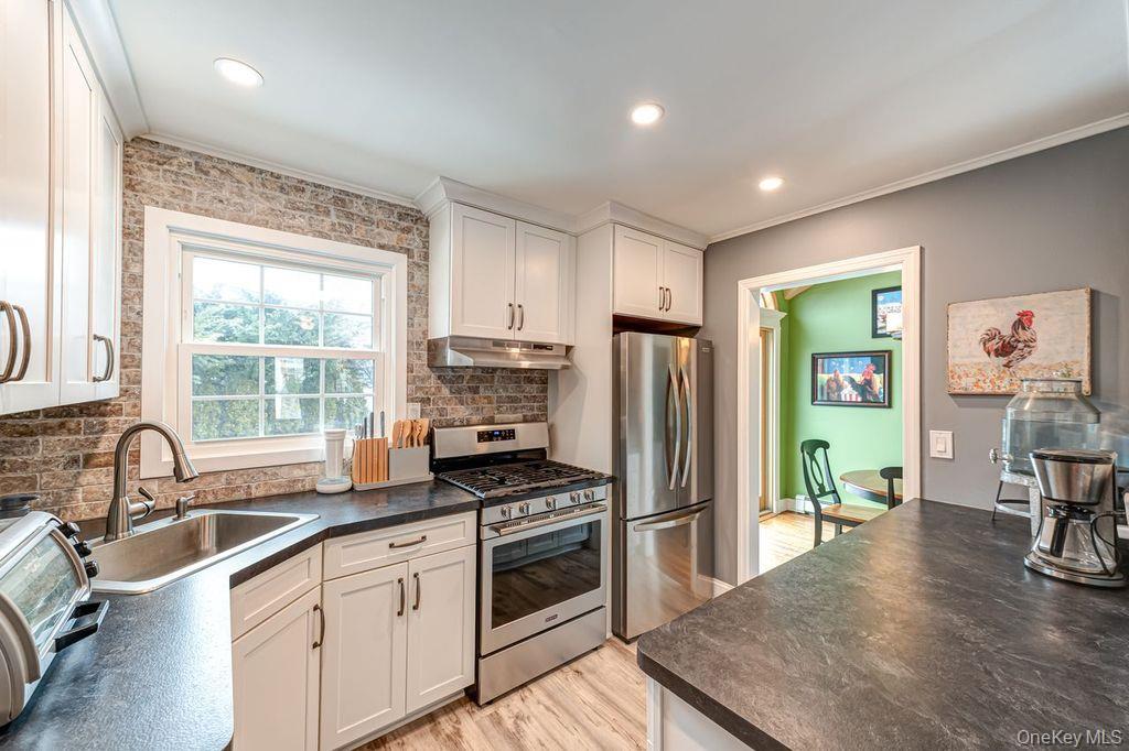 4 Hollyberry Road Plainview, NY 11803 - Photo 7 of 20 a kitchen with granite countertop a refrigerator and a sink