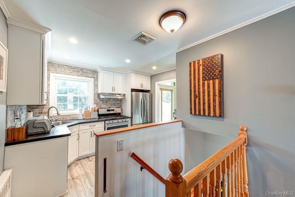 4 Hollyberry Road Plainview, NY 11803 - Photo 9 of 20 a kitchen that has a sink a window and stainless steel appliances