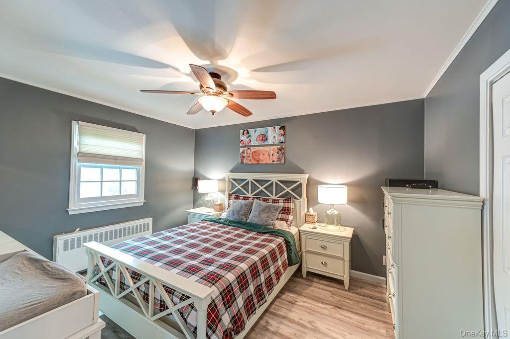 4 Hollyberry Road Plainview, NY 11803 - Photo 10 of 20 a bedroom with a bed and a chandelier