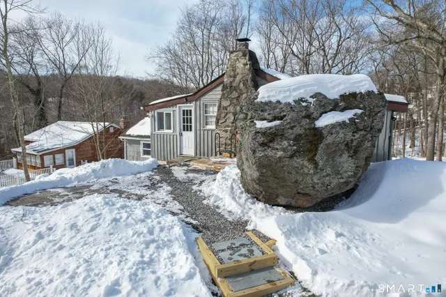 a view of a house with a snow in a yard