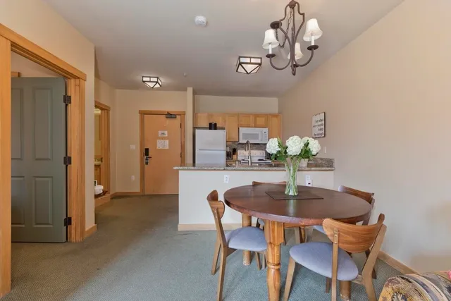 a dining room with furniture and chandelier