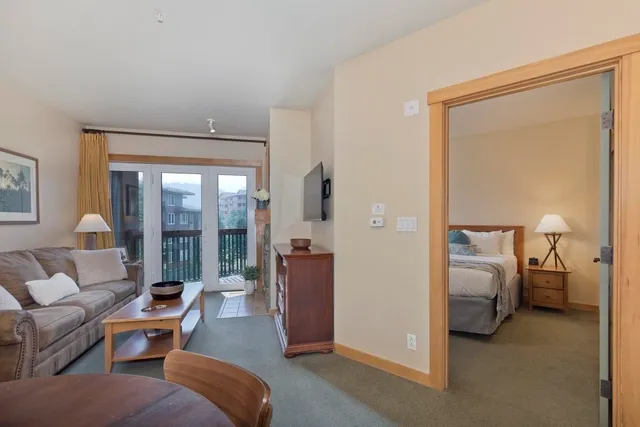 a living room with furniture and a balcony