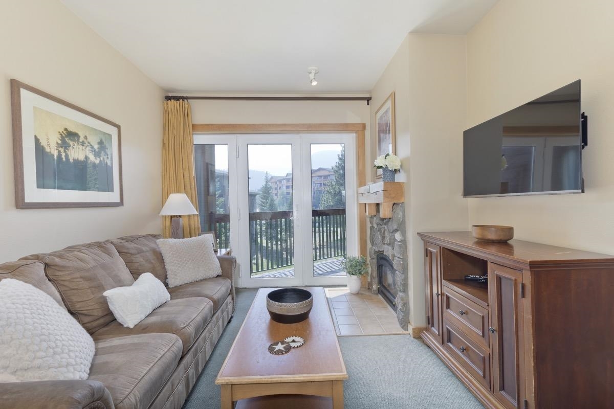 4000 Meridian Boulevard, Unit 436 Mammoth Lakes, CA 93546 - Photo 3 of 46 a living room with furniture and a flat screen tv