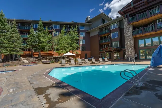 a view of a swimming pool with outdoor seating