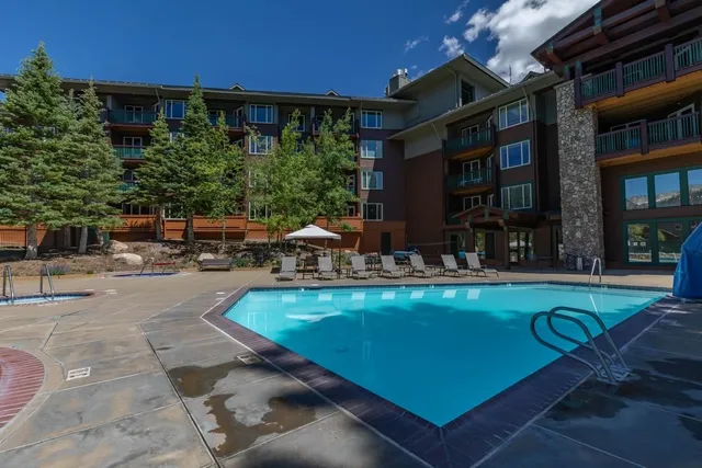 a view of swimming pool with outdoor seating and a patio