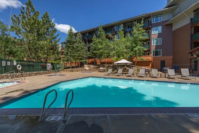 a swimming pool view with a outdoor seating