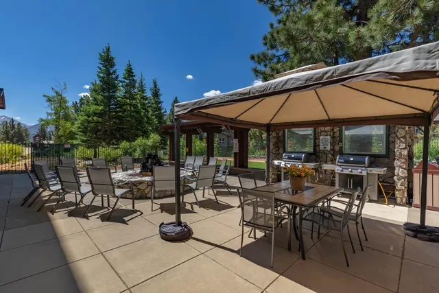 a view of patio with chairs and potted plants