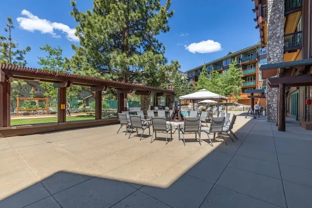 a view of a patio with chairs and tables