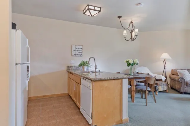 a kitchen with stainless steel appliances granite countertop a sink and refrigerator