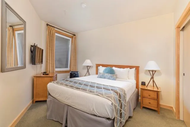 a bedroom with a bed and a night stand