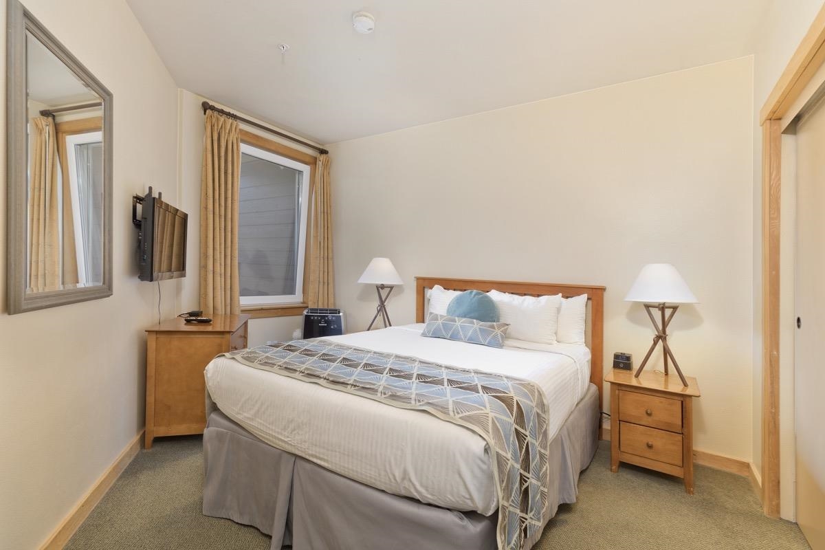 4000 Meridian Boulevard, Unit 436 Mammoth Lakes, CA 93546 - Photo 10 of 46 a bedroom with a bed and a night stand