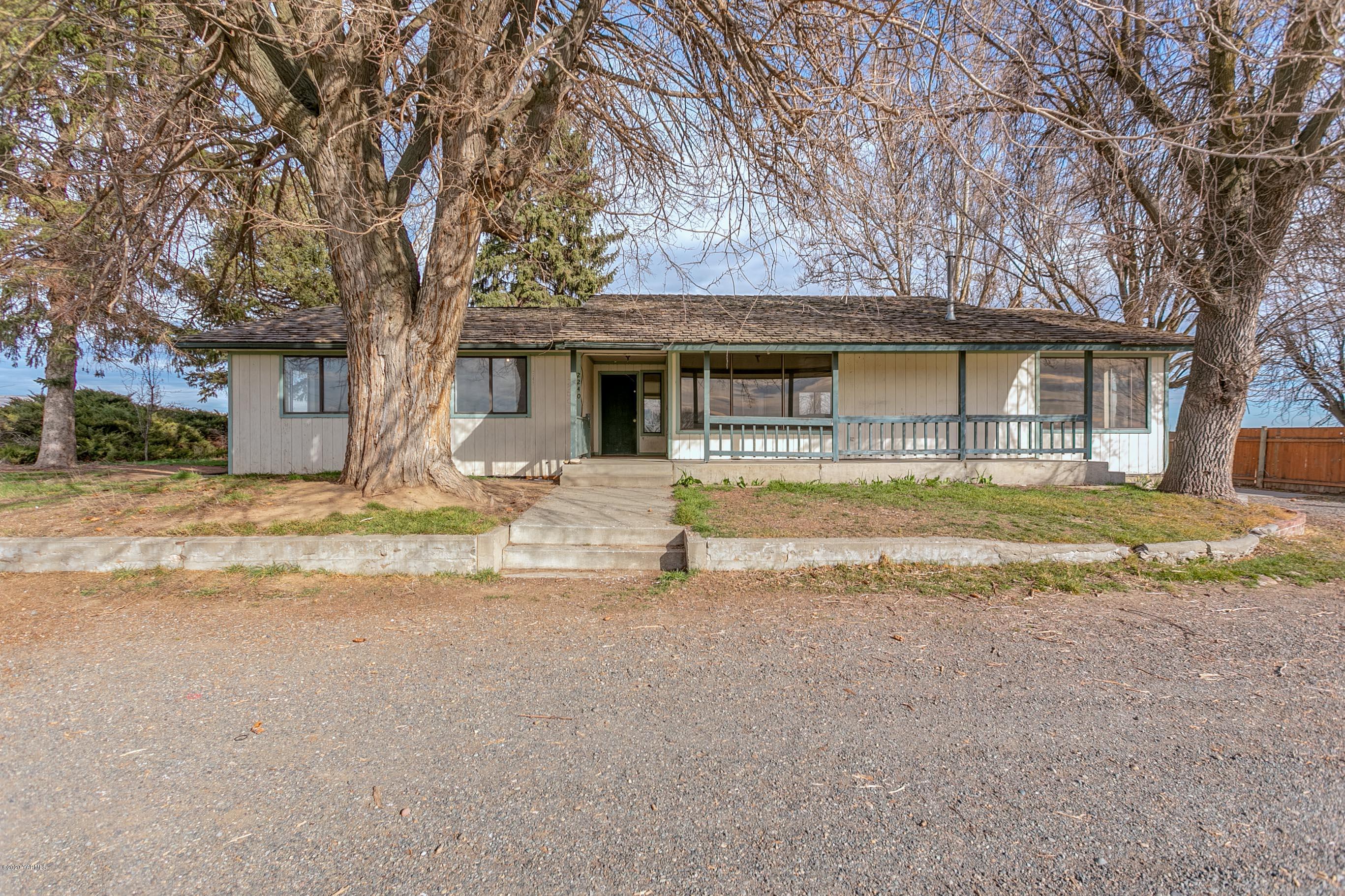 2240 Washout Road Sunnyside, WA 98944 - Photo 26 of 31 a house with trees in front of it