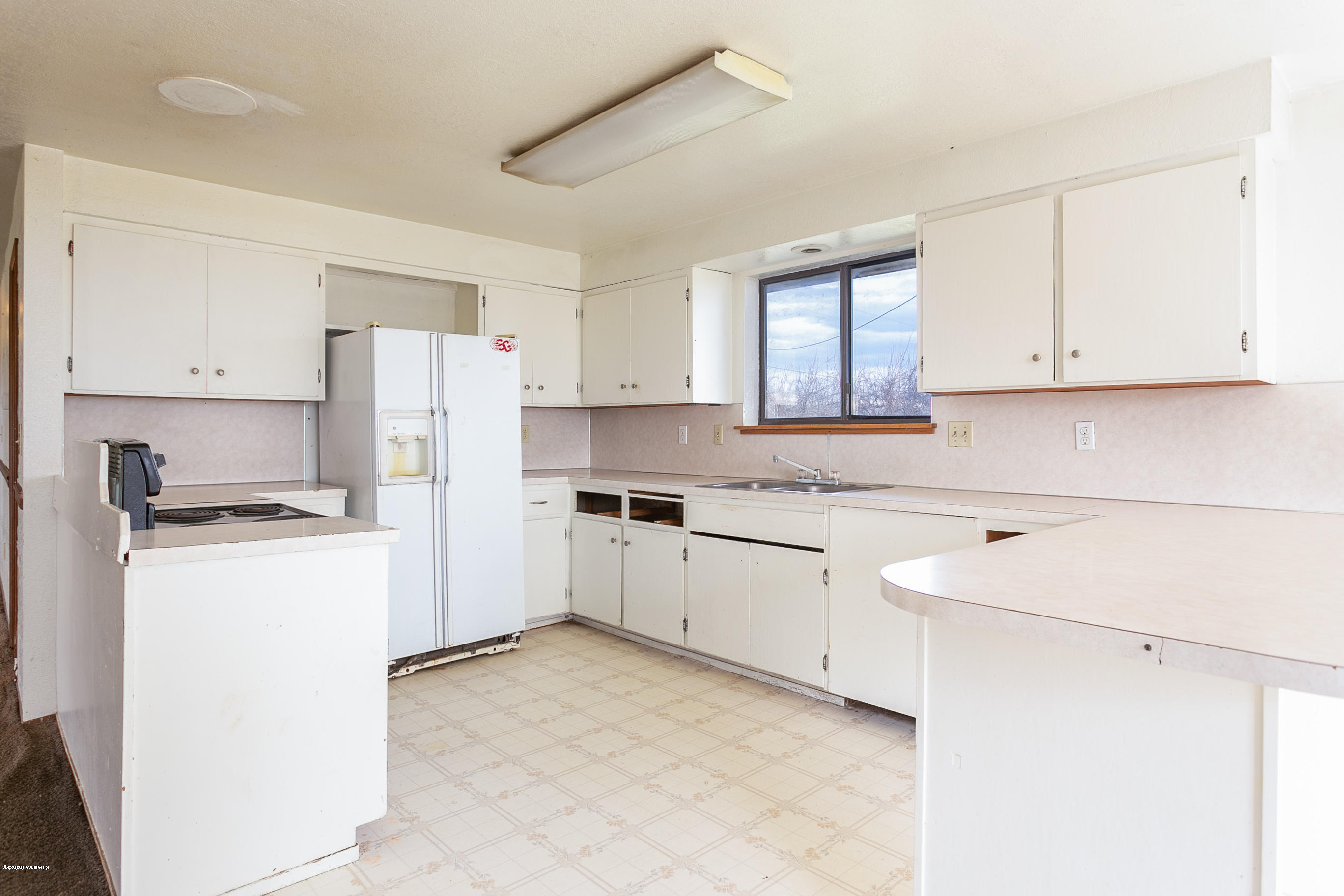 2240 Washout Road Sunnyside, WA 98944 - Photo 7 of 31 a kitchen with a refrigerator sink stove and cabinets