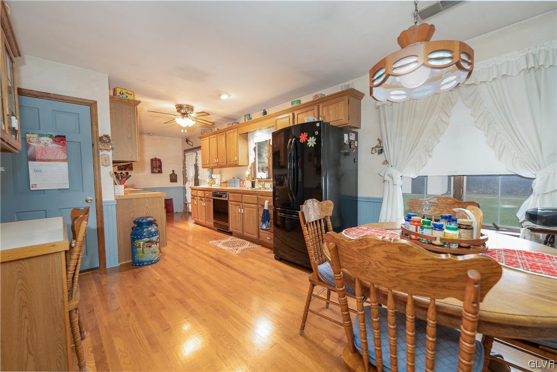 1685 Trexlertown Road Lower Macungie Township, PA 18062 - Photo 16 of 26 a kitchen with stainless steel appliances wooden floor dining table and chairs