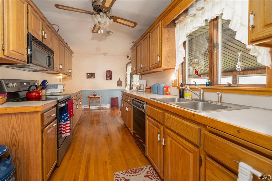 1685 Trexlertown Road Lower Macungie Township, PA 18062 - Photo 17 of 26 a kitchen with lots of counter top space and wooden floor