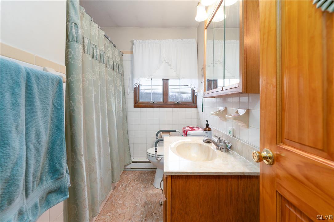 1685 Trexlertown Road Lower Macungie Township, PA 18062 - Photo 21 of 26 a bathroom with a sink and a mirror