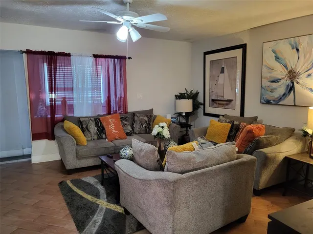 a living room with furniture and a chandelier
