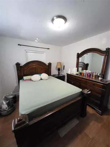 a bedroom with a bed and a dresser