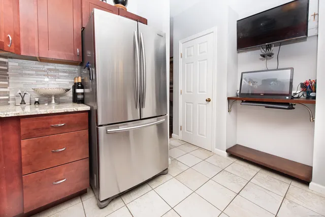 a kitchen with granite countertop a stove top oven microwave and cabinets