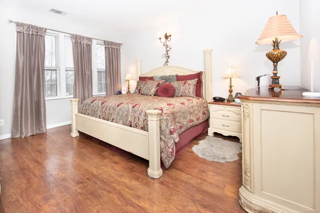 a bedroom with a bed and a chandelier