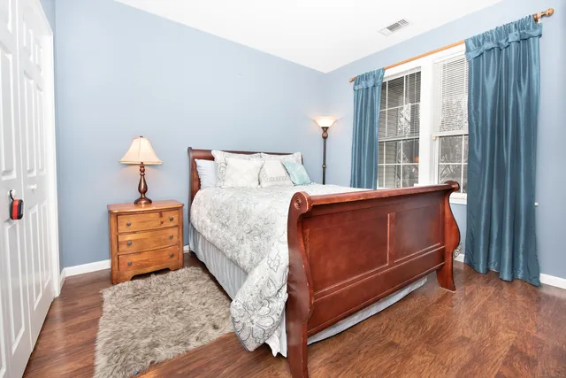 a bed sitting in a bedroom next to a window