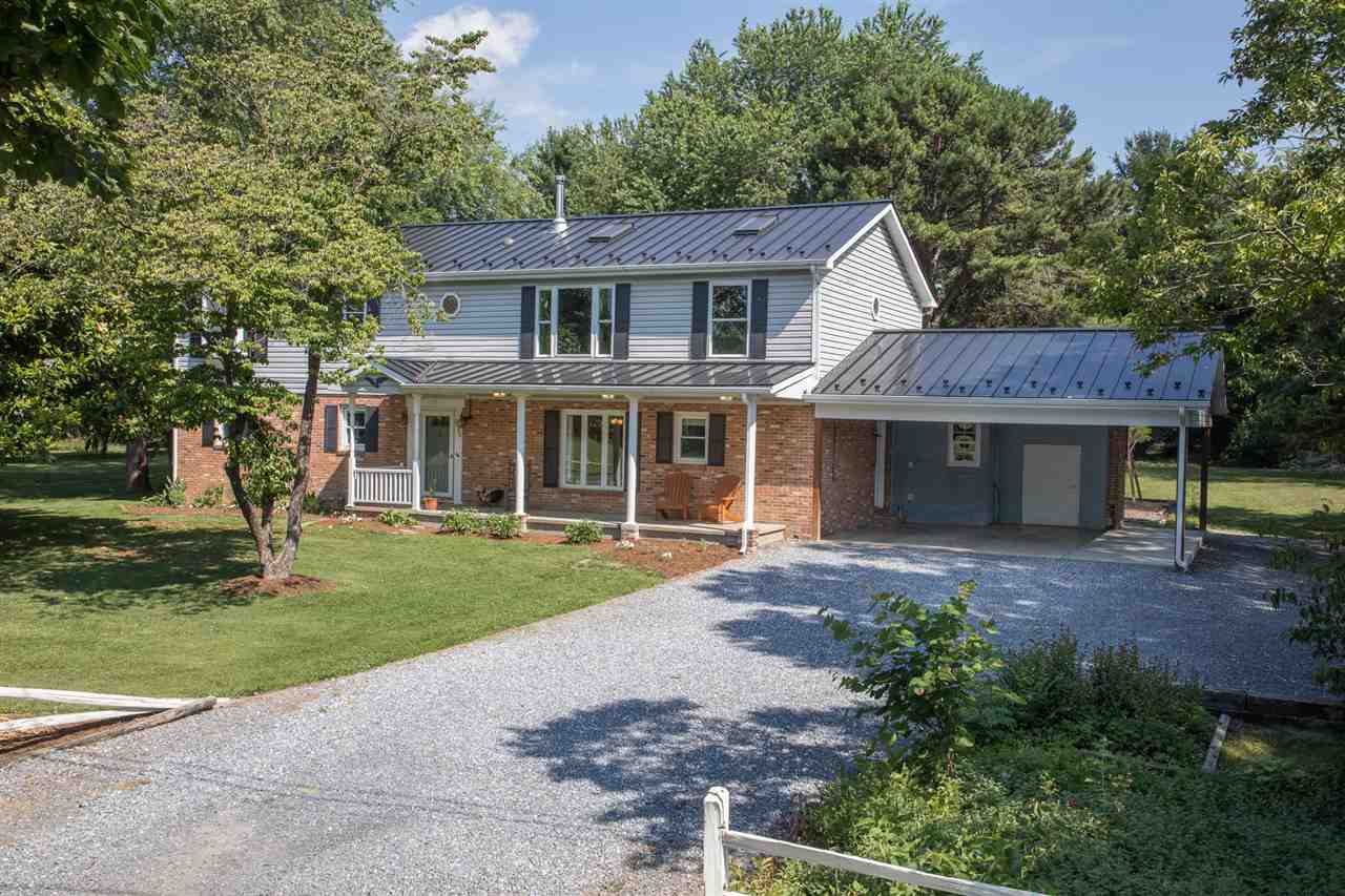 2888 Kerns Road Dayton, VA 22821 - Photo 1 of 49 a front view of a house with a garden and trees