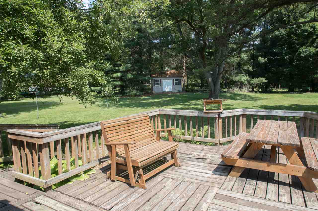 2888 Kerns Road Dayton, VA 22821 - Photo 28 of 49 a view of a wooden deck and lake with trees in the background