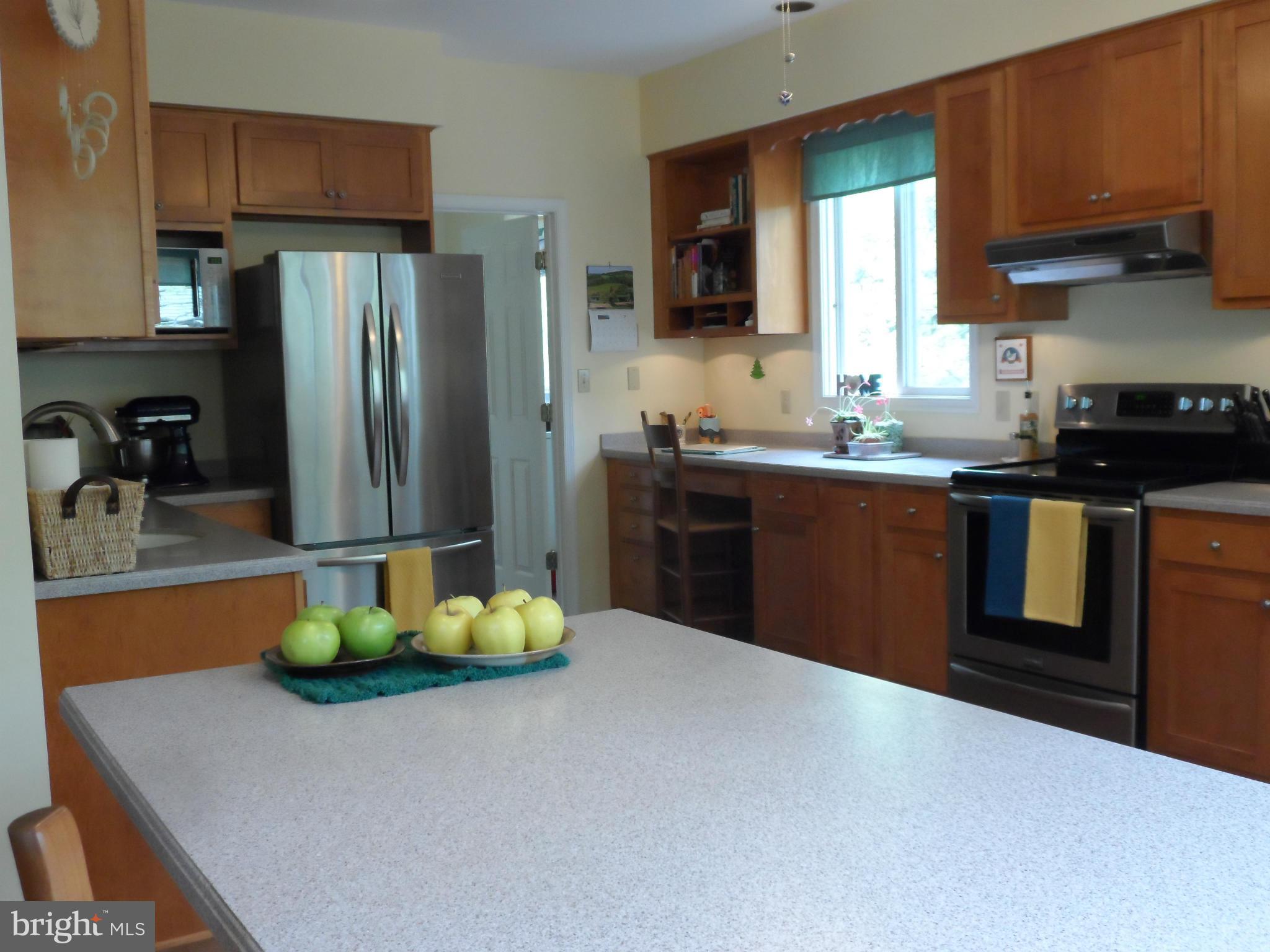7244 Peppermill Road King George, VA 22485 - Photo 17 of 30 a kitchen with stainless steel appliances granite countertop a sink refrigerator stove and microwave