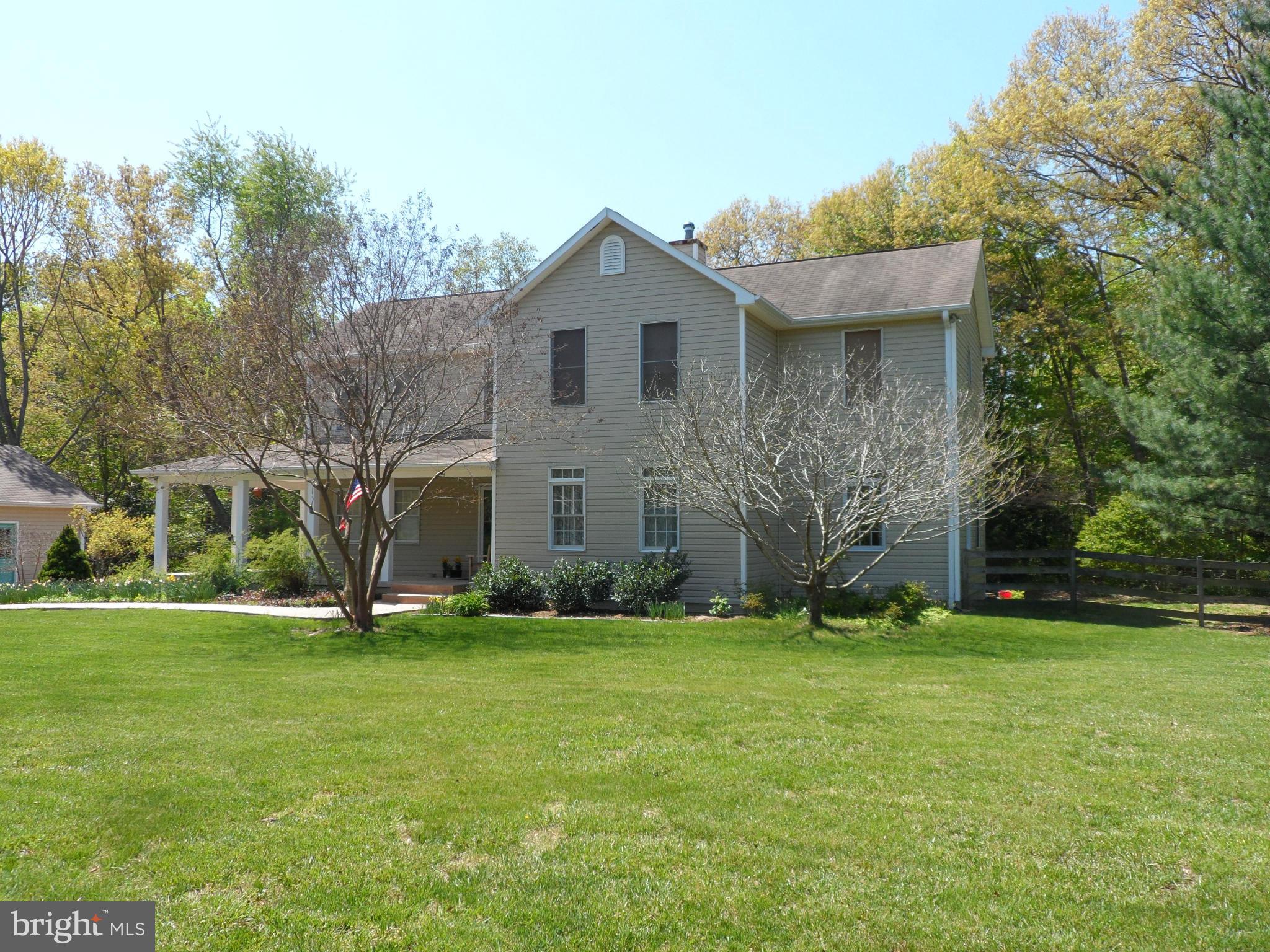 7244 Peppermill Road King George, VA 22485 - Photo 4 of 30 a front view of a house with a yard