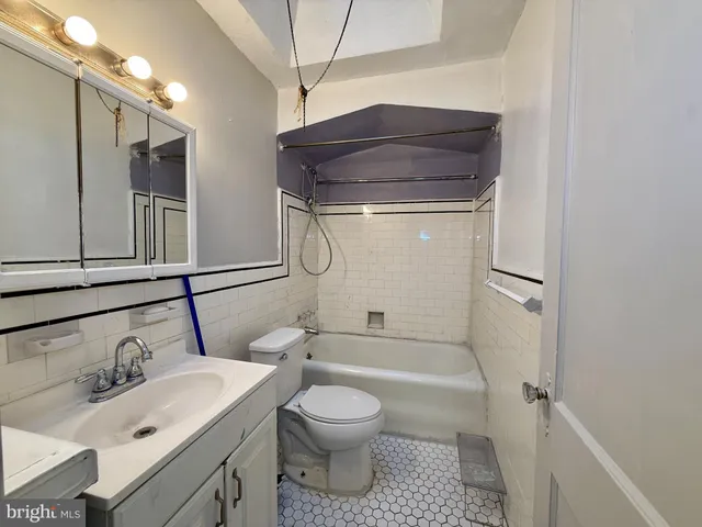 a bathroom with a toilet a sink and a mirror