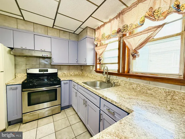 a kitchen with stainless steel appliances a refrigerator sink and cabinets