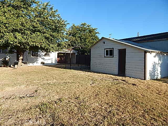 818 South Tehama Street Willows, CA 95988 - Photo 3 of 12 a front view of a house with a yard and garage